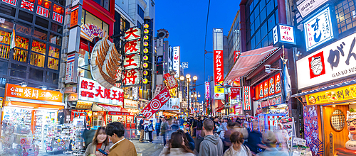 View of colourful facades of restaurants in Dotonbori, vibrant entertainment district near the river, Osaka, Honshu, Japan