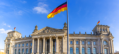 View of the German flag and Reichstag (German Parliament building), Mitte, Berlin, Germany, Europe