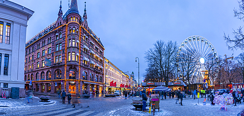 View of architecture on Karl Johans Gate and Christmas market during winter at dusk, Oslo, Norway, Scandinavia, Europe