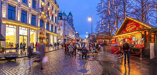 View of cafes, bars and Christmas market on Karl Johans Gate during winter at dusk, Oslo, Norway, Scandinavia, Europe