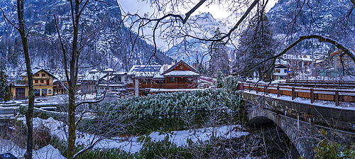 View of hotels and lodges with mountains in background during winter, Courmayeur, Aosta Valley, Italy, Europe