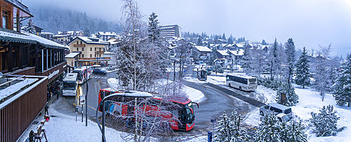 View of bus station and the snow covered town centre in winter, Courmayeur, Aosta Valley, Italy, Europe