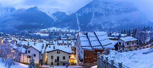 View of the snow covered town centre and mountainous background in winter, Courmayeur, Aosta Valley, Italy, Europe