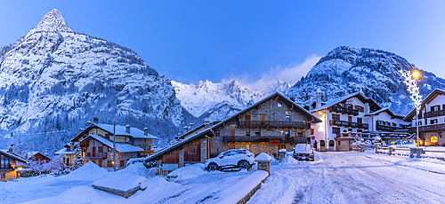 View of chalets and snow covered mountains in Courmayeur before dawn during winter, Courmayeur, Aosta Valley, Italy, Europe