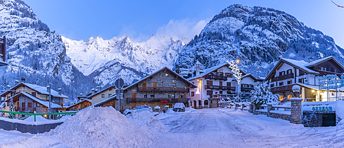 View of chalets and snow covered mountains in Courmayeur before dawn during winter, Courmayeur, Aosta Valley, Italy, Europe