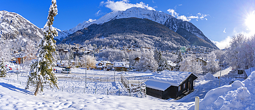 View of snow covered trees, mountains and Courmayeur from Dolonne during winter, Courmayeur, Aosta Valley, Italy, Europe