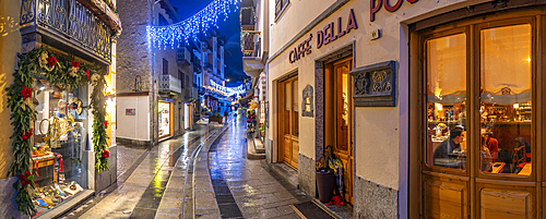 View of shops in town centre on Via Roma in Courmayeur during winter, Courmayeur, Aosta Valley, Italy, Europe