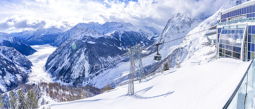 View of snow covered Aosta Valley, mountains and Skyway Monte Bianco cable car in winter, Courmayeur, Aosta Valley, Italy, Europe