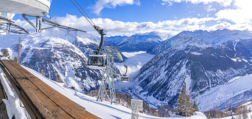 View of snow covered Aosta Valley, mountains and Skyway Monte Bianco cable car in winter, Courmayeur, Aosta Valley, Italy, Europe