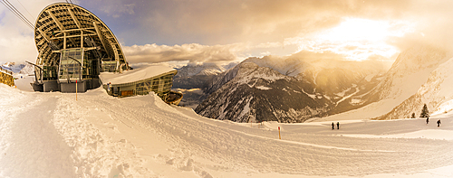 View of snow covered Aosta Valley, mountains and Skyway Monte Bianco cable car station in winter, Courmayeur, Aosta Valley, Italy, Europe