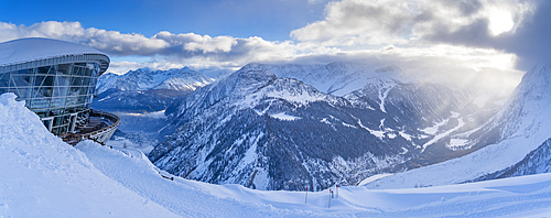 View of snow covered Aosta Valley, mountains and Skyway Monte Bianco cable car station in winter, Courmayeur, Aosta Valley, Italy, Europe