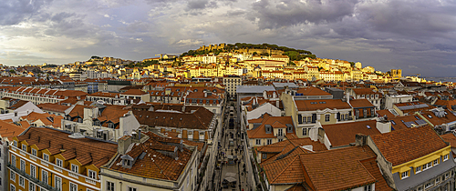 View of city rooftops and Lisbon Castle from Santa Justa Lift during golden hour, Lisbon, Portugal, Europe