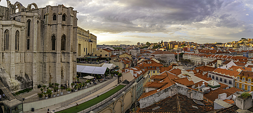 View of city rooftops and Carmo Archaeological Museum from Santa Justa Lift during golden hour, Lisbon, Portugal, Europe