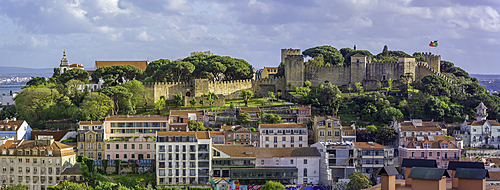 Panoramic view of Lisbon Castle from Miradouro da Senhora do Monte scenic point on a sunny day in the Alfama District, Lisbon, Portugal, Europe