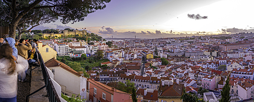 Panoramic view of Lisbon Castle from Miradouro da Senhora do Monte scenic point at dusk in the Alfama District, Lisbon, Portugal, Europe