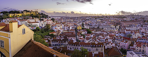 Panoramic view of Lisbon Castle from Miradouro da Senhora do Monte scenic point at dusk in the Alfama District, Lisbon, Portugal, Europe