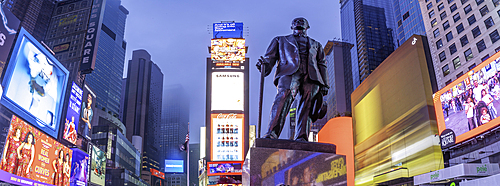 View of neon lights in Times Square at dusk, New York City, United States of America, North America