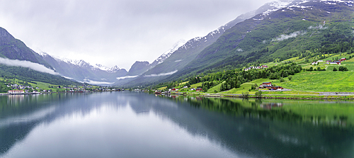 View of Olden village and mountains reflecting in Nordfjorden during summer, Norway, Scandinavia, Europe