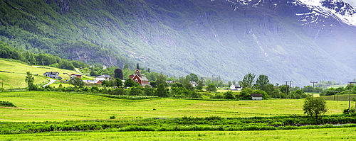 View of Olden New Church in Olden village and mountains in Nordfjorden during summer, Norway, Scandinavia, Europe