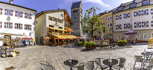View of St. Hippolyte Church and cafe in Stadtplatz in Zell am See on a sunny day, Zell am See, Salzburg, Austria, Europe
