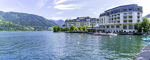 View of the Grand Hotel on Lake Zell from Zell am See and mountainous backdrop on a sunny day, Zell am See, Salzburg, Austria, Europe