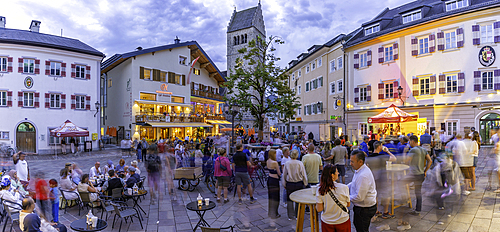 View of St. Hippolyte Church and cafe in Stadtplatz in Zell am See at dusk, Zell am See, Salzburg, Austria, Europe