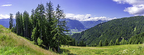 View of Kaprun and mountains toward Grossglockner from Plettsaukopf Reservoir on a sunny day, Bruckberg, Salzburg, Austria, Europe