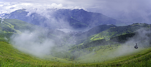 View of cable car, Zell am See and cloud from Schmittenhöhebahn top station 2000m on a sunny day, Zell am See, Salzburg, Austria, Europe
