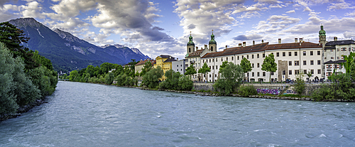 View of St. Jakob Cathedral, colourful buildings and River Inn during golden hour in summer, Innsbruck, Tyrol Region, Austria, Europe