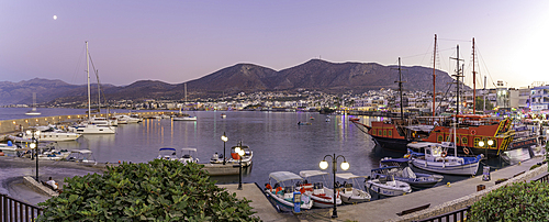View of boats in Port of Limenas Chersonisou at dusk, Limenas Chersonisou, Crete, Greek Islands, Greece, Europe