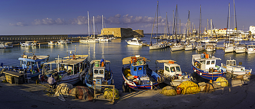 View of Koules Venetian Fortress and boats in Heraklion Venetian Port at sunset, City of Heraklion, Crete, Greek Islands, Geece, Europe
