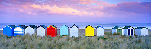 Colourful beach huts and sand dunes at sunset, Southwold, Suffolk, England, United Kingdom, Europe