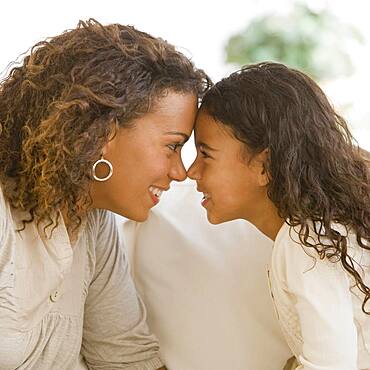 African mother and daughter touching noses