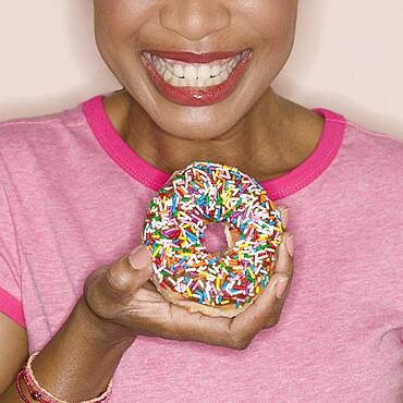 Close up of woman holding donut