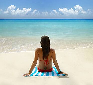 Caucasian woman laying on tropical beach