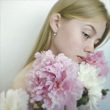 Close up of Caucasian teenage girl holding flowers