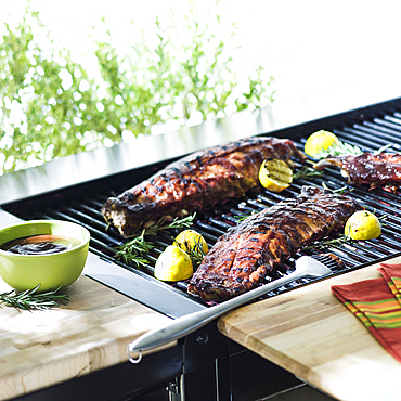 Beef ribs cooking on barbecue grille