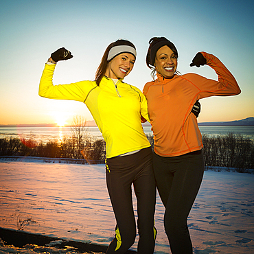 Runners posing and flexing muscles in winter