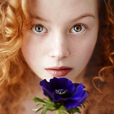 Caucasian teenage girl holding flower