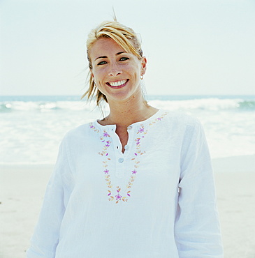 Portrait of smiling woman on beach