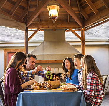 Family enjoying dinner on patio