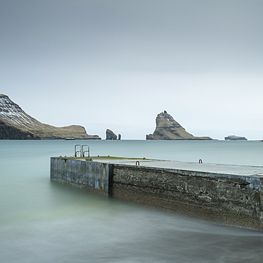 Pier and sea stacks from the shores of Bour, Vagar Island, Faroe Islands, Denmark, Europe