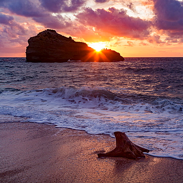 Sunset over Roche Ronde rock off the coast of Biarritz, Pyrenees Atlantiques, Aquitaine, France, Europe