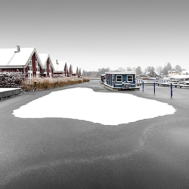 Snowy houseboat on the Scharmuetzelsee, Germany, Europe