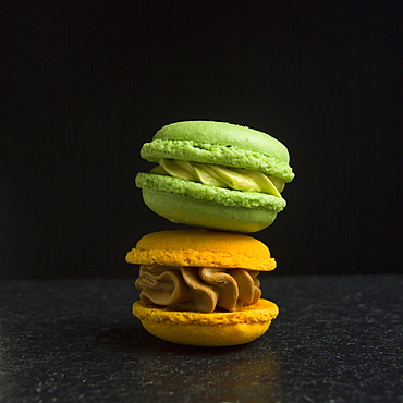 Two macarons on a black background