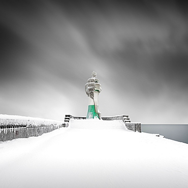 Iced lighthouse in the harbour of Sassnitz, Ruegen, Germany, Europe