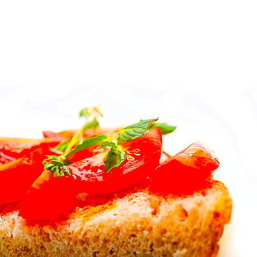 Italian tomato bruschetta with thyme and mint leaves