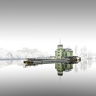 Long exposure of the winter landscape around the Helmovsky jez hydroelectric power plant power station on the Vltava River in Prague, Czech Republic, Europe