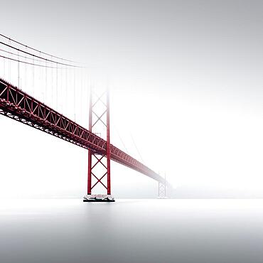 Minimalist long exposure of the Golden Gate Bridge's little sister. The Ponte 25 de Abril bridge over the Tagus River in Lisbon, Portugal, Europe