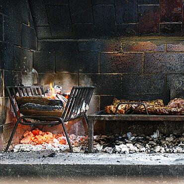 Flames of fire and roasted meat. Argentinian barbecue